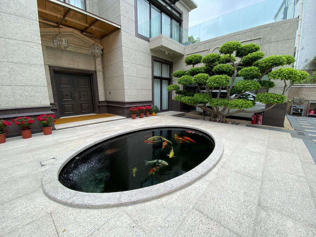 A circular fish pond with a beautiful landscape